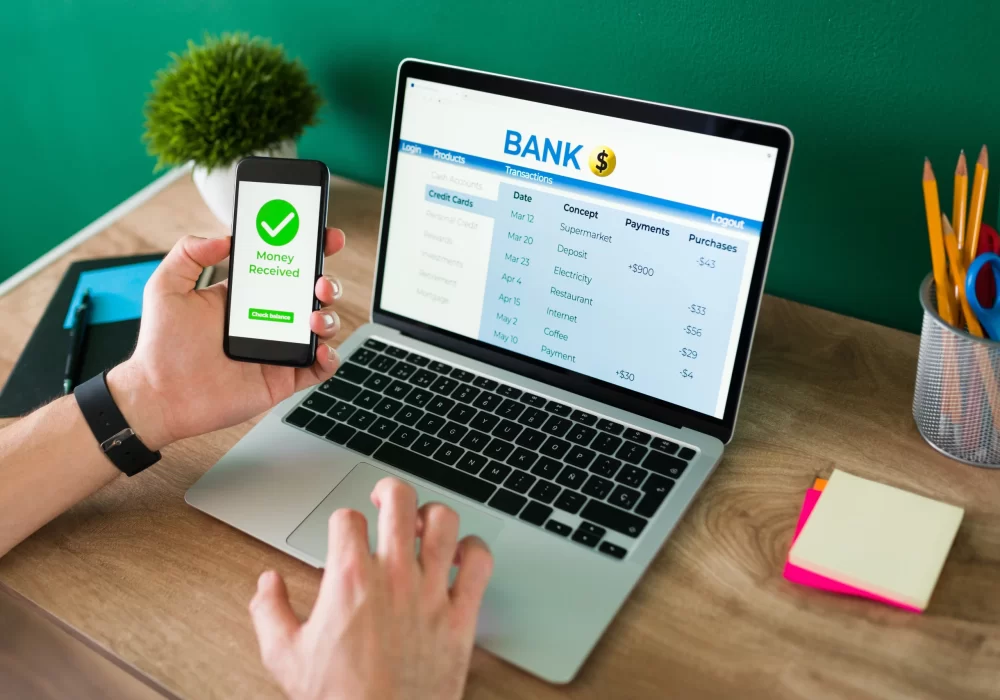 wire-transfer-young-man-using-his-smartphone-laptop-banking-transaction-some-payments